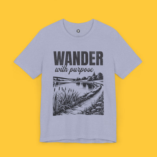 T-shirt featuring a landscape silhouette of a lake with a path beside it and the quote "Wander with Purpose," symbolizing life’s journey.