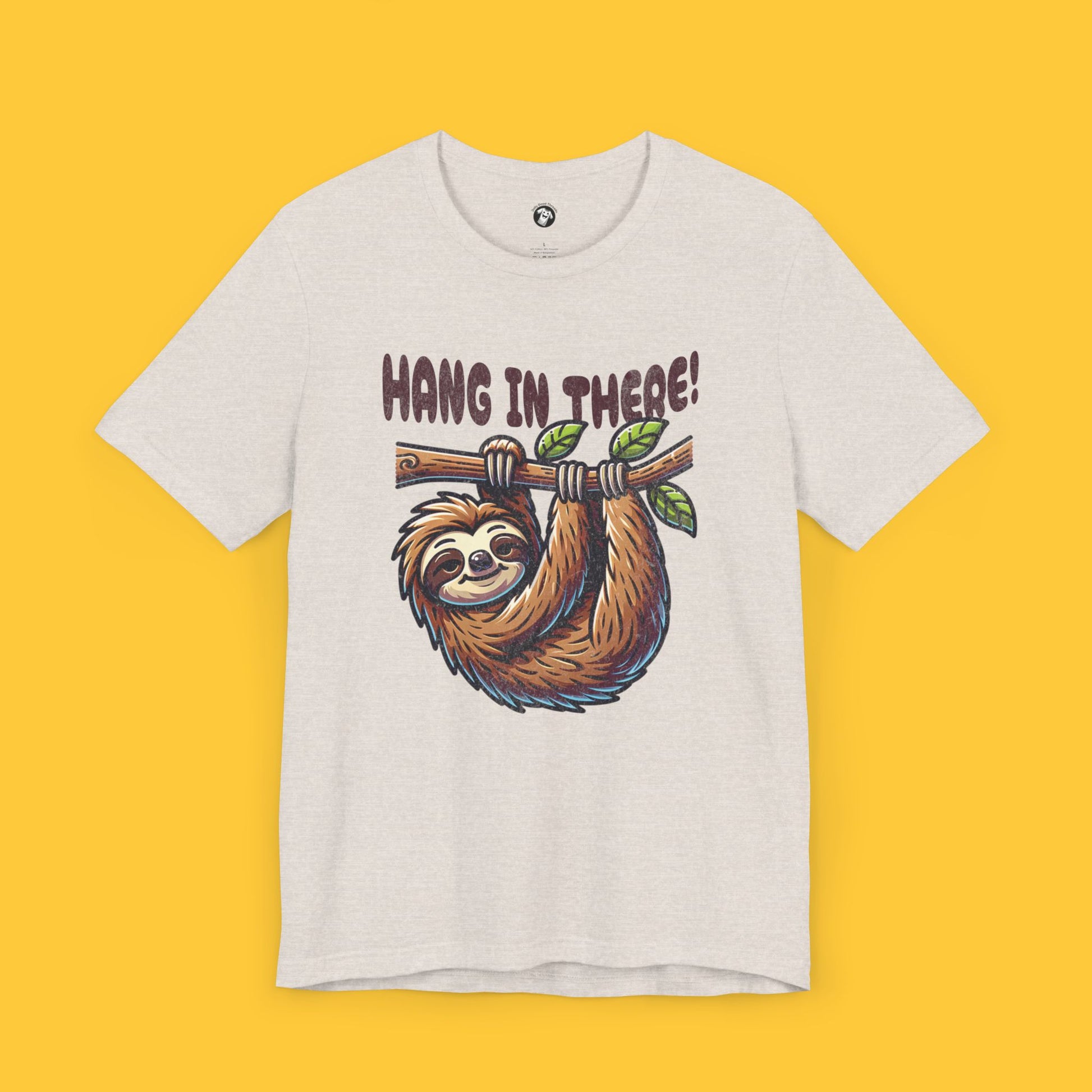 T-shirt with a cute sloth hanging from a branch and the quote "HANG IN THERE!" in a bubbly font.