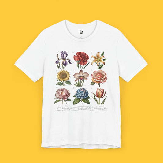 T-shirt featuring a vintage-style floral illustration with various flowers and their scientific names.