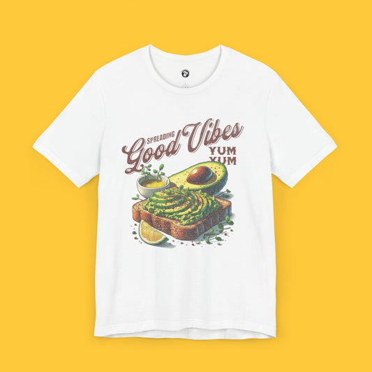 T-shirt featuring a graphic of avocado toast with the quote "Spreading Good Vibes" in vintage-inspired typography.