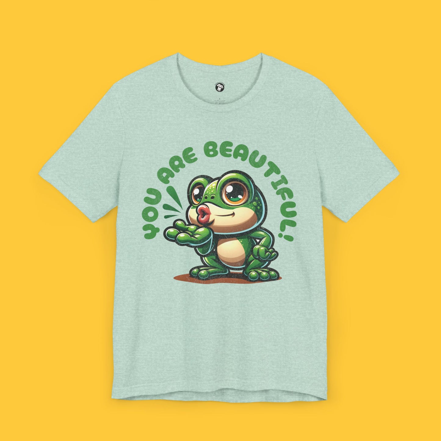 T-shirt with a cute frog character blowing a kiss and the quote "You Are Beautiful!" in a bubbly font.