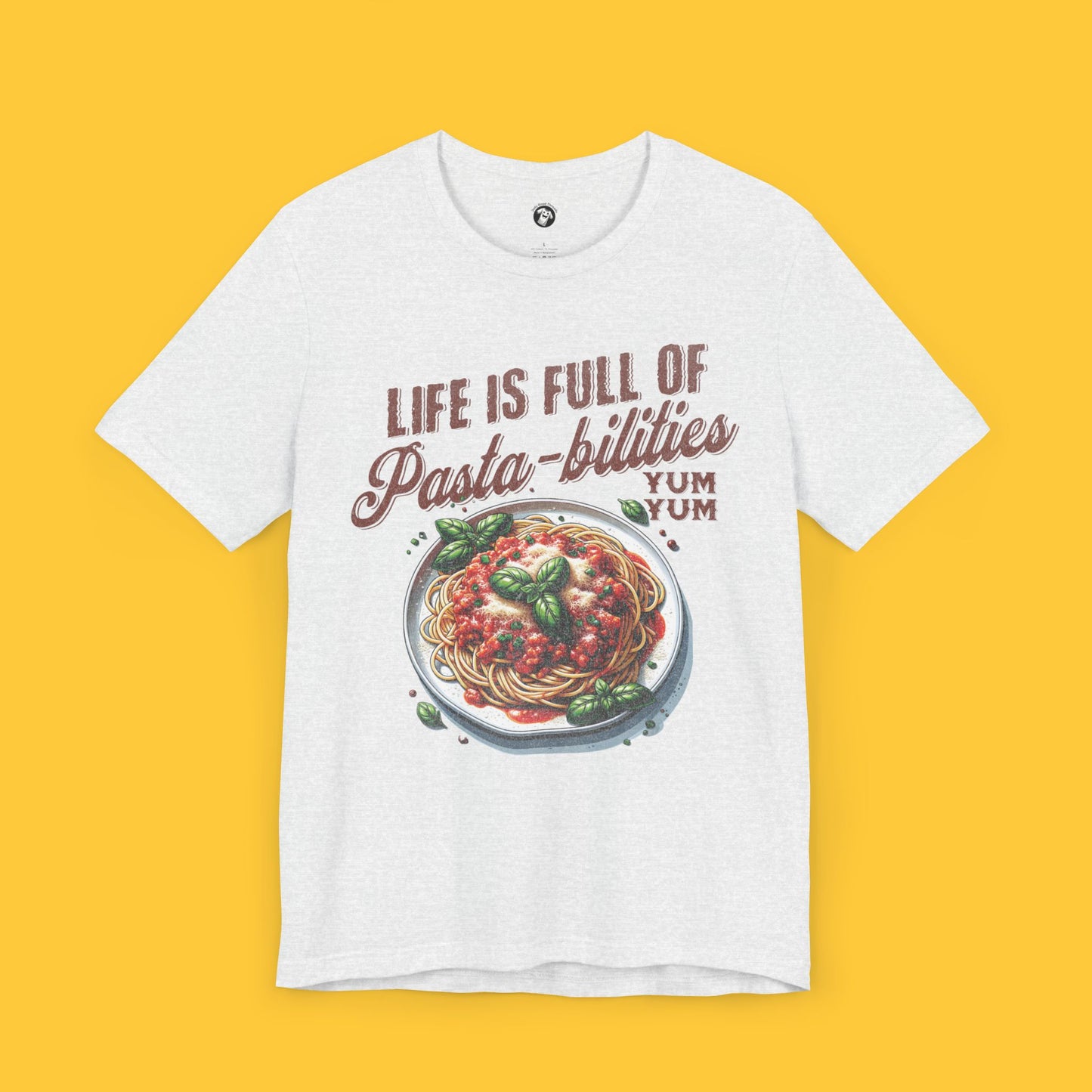 T-shirt featuring a detailed graphic of a spaghetti plate with the quote "Life Is Full of Pasta-bilities" in a playful font.